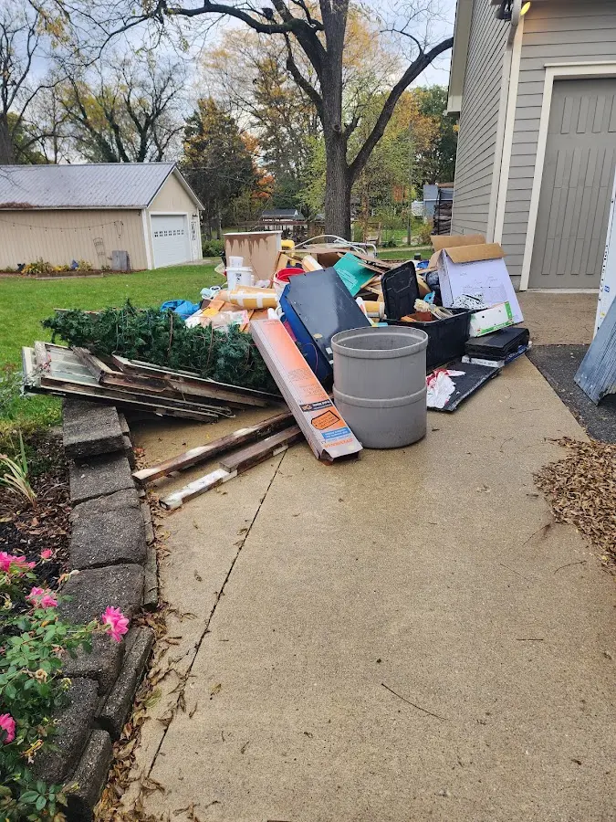 Dumpster being loaded with debris for Commercial Dumpster Rental in Pinetop-Lakeside